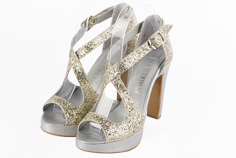 Gold women's closed back sandals, with crossed straps. Round toe. Very high slim heel with a platform at the front. Front view - Florence KOOIJMAN